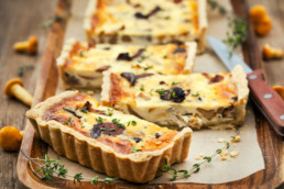 Quiche on wooden tray